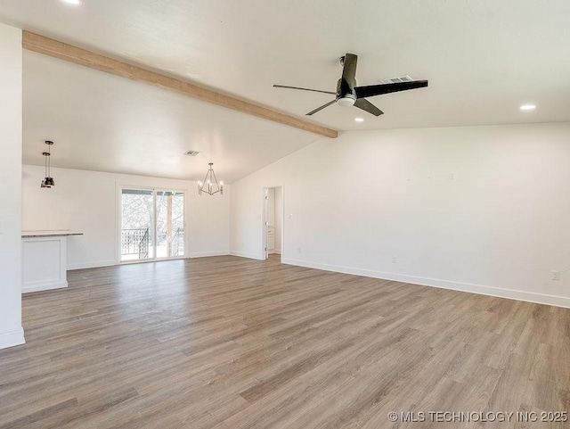 unfurnished living room featuring visible vents, baseboards, lofted ceiling with beams, ceiling fan with notable chandelier, and light wood-style floors