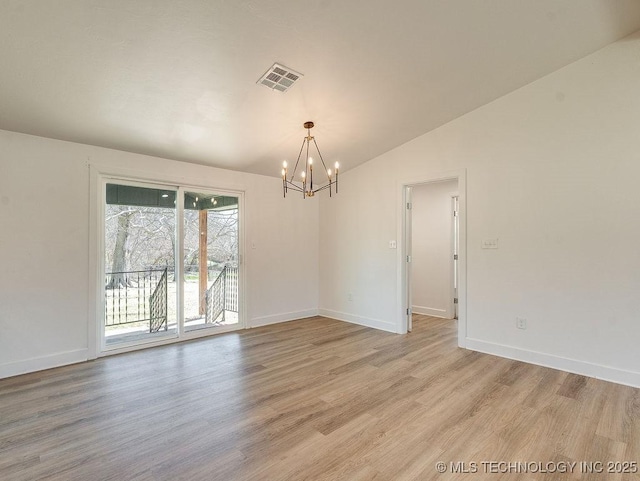 empty room featuring visible vents, light wood finished floors, baseboards, and vaulted ceiling