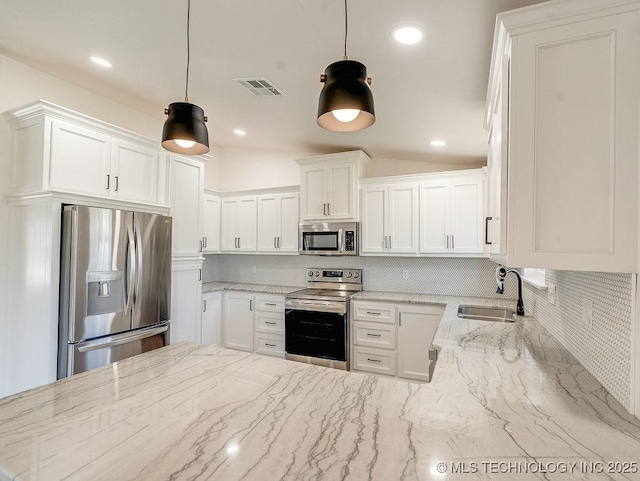 kitchen with a sink, visible vents, white cabinetry, and stainless steel appliances