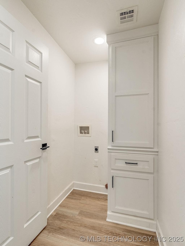 clothes washing area featuring hookup for a washing machine, baseboards, visible vents, electric dryer hookup, and light wood-type flooring