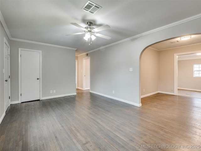 spare room with arched walkways, visible vents, ceiling fan, and wood finished floors