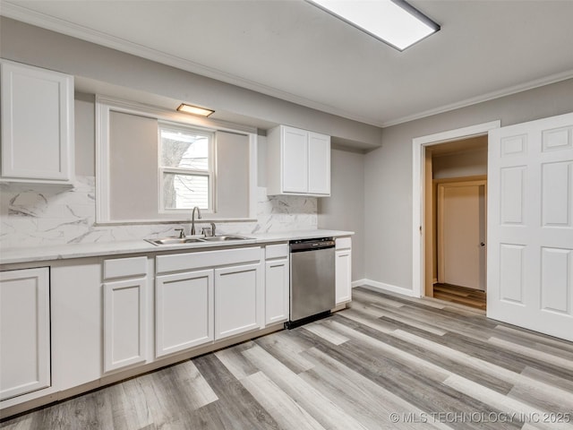 kitchen featuring a sink, dishwasher, white cabinets, and ornamental molding