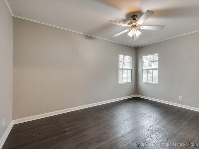 spare room featuring crown molding, dark wood-type flooring, and baseboards