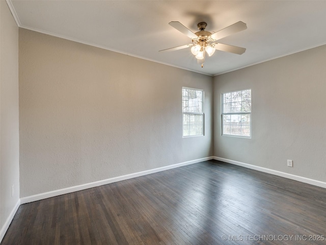 empty room with baseboards, dark wood-style floors, and crown molding