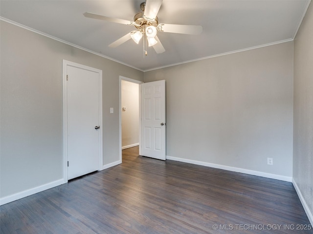 unfurnished room featuring baseboards, dark wood-style floors, and ornamental molding