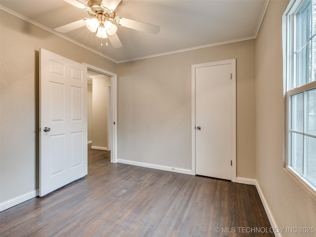 unfurnished bedroom featuring ceiling fan, baseboards, wood finished floors, and crown molding