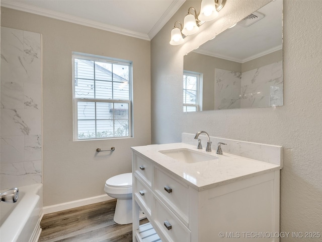 full bathroom featuring toilet, wood finished floors, crown molding, baseboards, and vanity