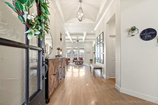 foyer featuring beamed ceiling, light wood-style flooring, coffered ceiling, and baseboards