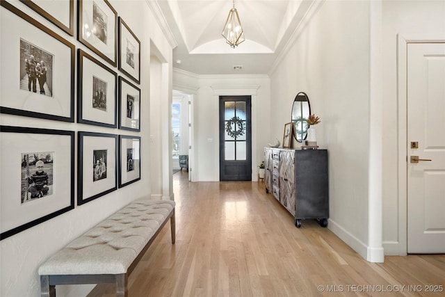 entrance foyer featuring light wood-type flooring, baseboards, and ornamental molding