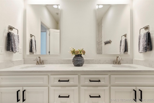 full bathroom featuring a sink and double vanity