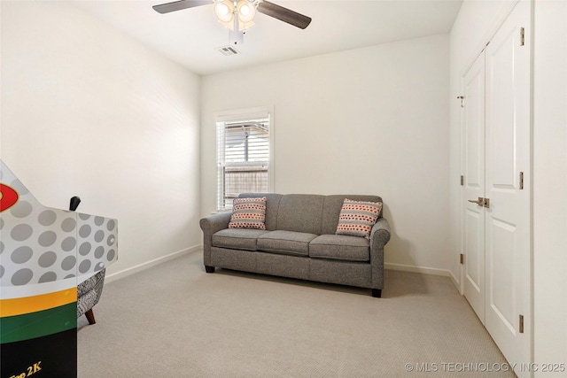 living area featuring carpet flooring, a ceiling fan, visible vents, and baseboards