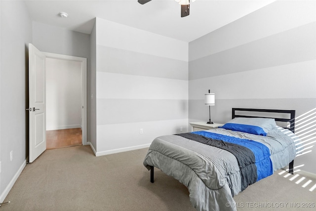 carpeted bedroom featuring a ceiling fan and baseboards