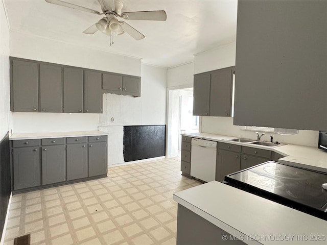 kitchen featuring visible vents, light floors, gray cabinets, white dishwasher, and a sink