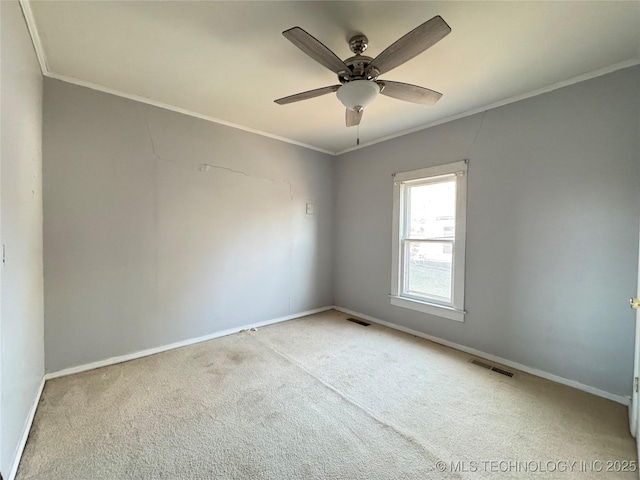 unfurnished room with visible vents, baseboards, carpet, and ornamental molding