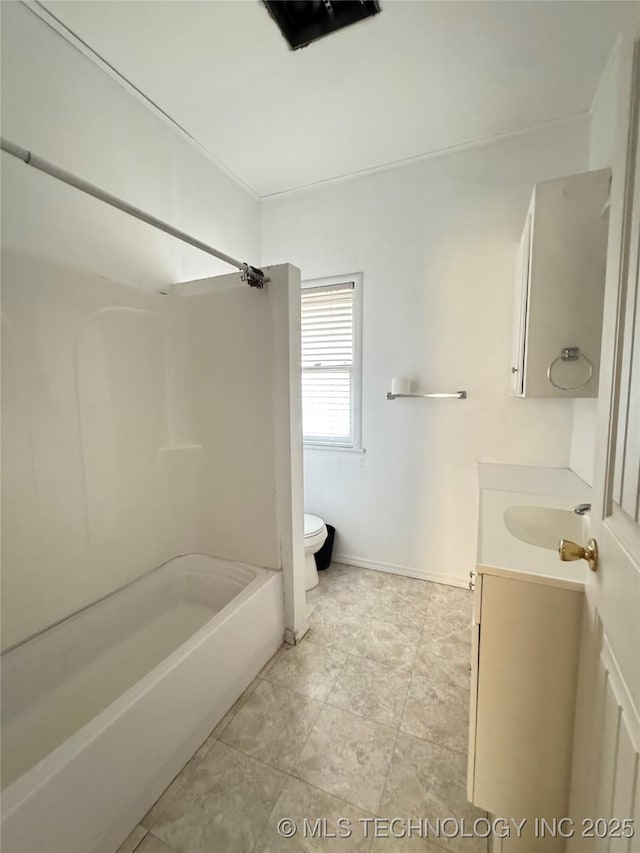 bathroom with vanity, shower / tub combination, toilet, and baseboards