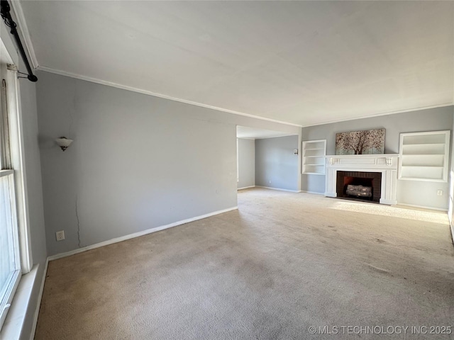 unfurnished living room featuring built in shelves, baseboards, carpet floors, a fireplace with flush hearth, and crown molding