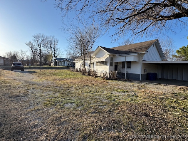 view of side of property with an attached carport