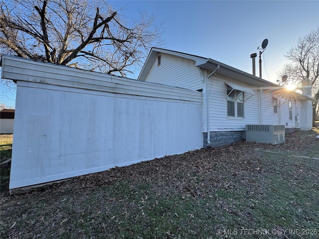 view of side of home with central air condition unit