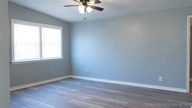 spare room with baseboards, wood finished floors, and a ceiling fan