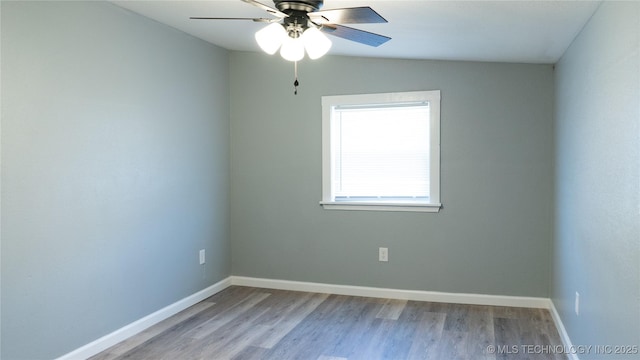 spare room with ceiling fan, baseboards, and wood finished floors