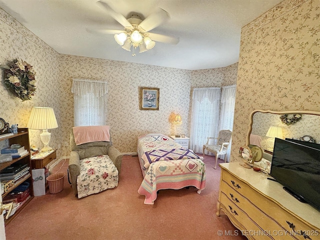 carpeted bedroom with ceiling fan and wallpapered walls