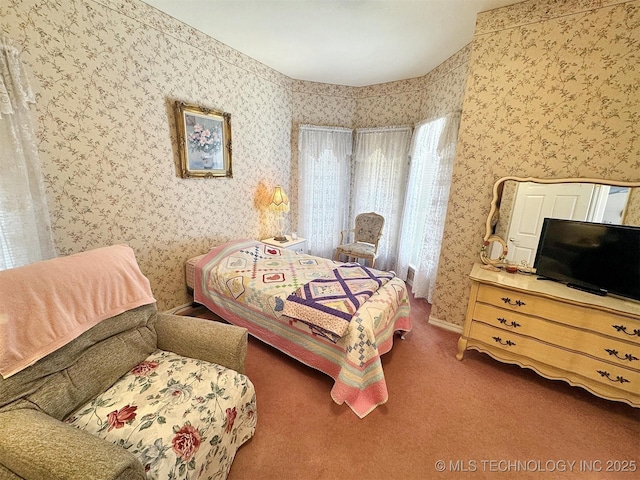 bedroom with carpet flooring and wallpapered walls