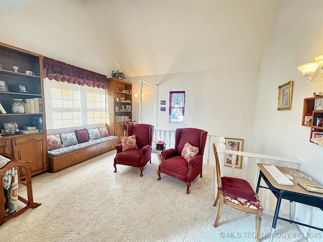 sitting room featuring lofted ceiling and carpet