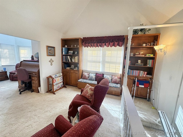 living area featuring light colored carpet, high vaulted ceiling, and a healthy amount of sunlight