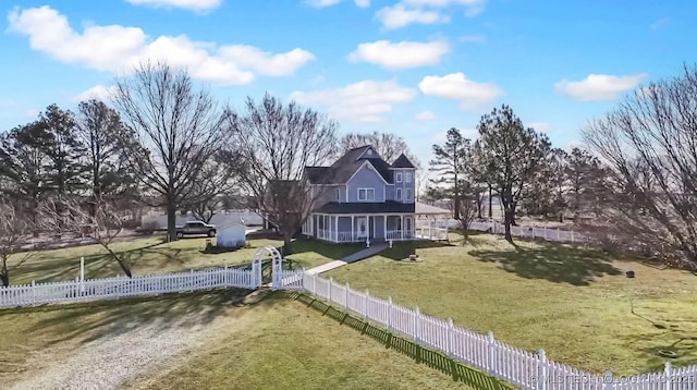 exterior space featuring a fenced front yard, a front lawn, and a gate