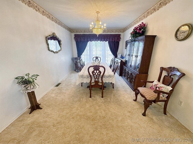 carpeted dining area featuring visible vents, baseboards, and a notable chandelier