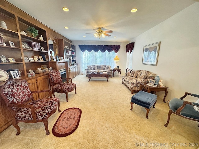 living area featuring a ceiling fan, recessed lighting, and carpet