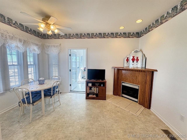 dining space featuring visible vents, baseboards, and a fireplace