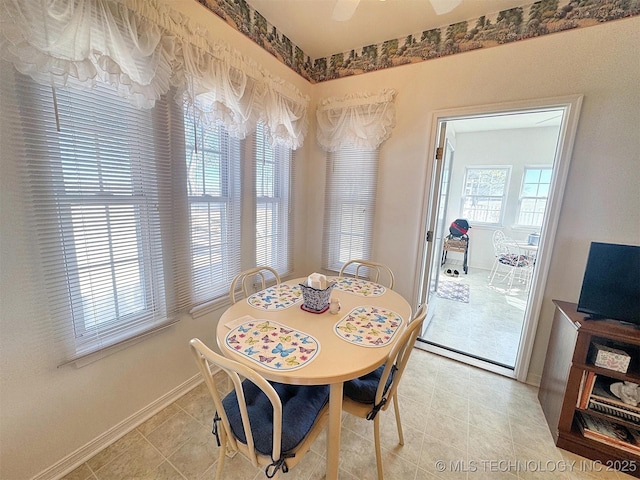 dining room featuring light tile patterned floors and baseboards