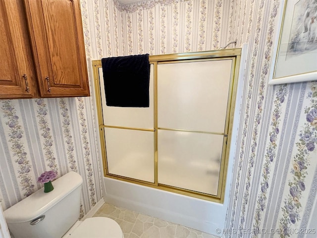 bathroom featuring enclosed tub / shower combo, tile patterned flooring, toilet, and wallpapered walls