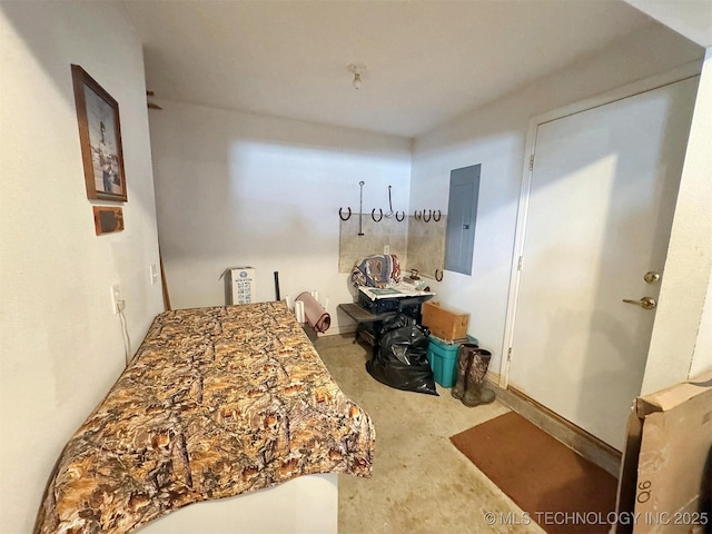 bedroom featuring electric panel and concrete floors