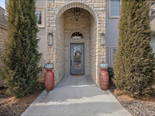 entrance to property featuring stone siding