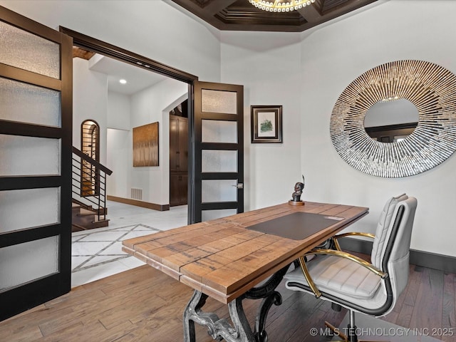 office featuring visible vents, baseboards, and hardwood / wood-style flooring