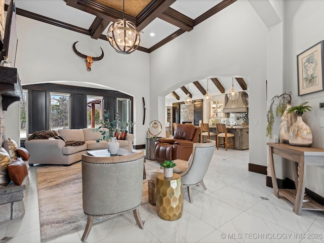 living room featuring beamed ceiling, a notable chandelier, marble finish floor, ornamental molding, and arched walkways