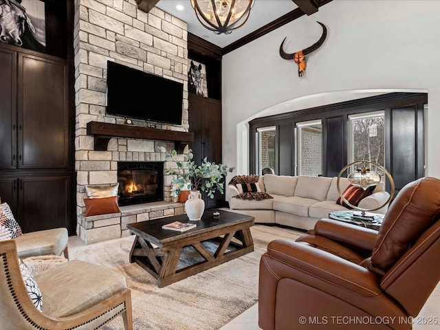 living room with a chandelier, a fireplace, and crown molding