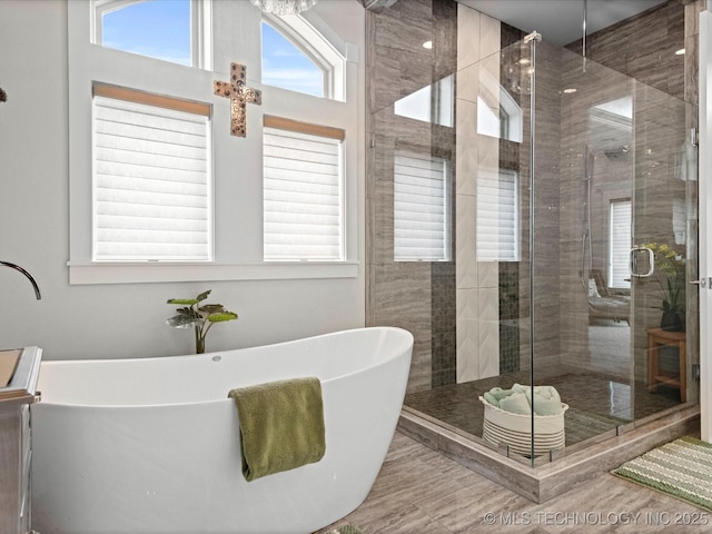 full bath featuring a shower stall and a freestanding tub