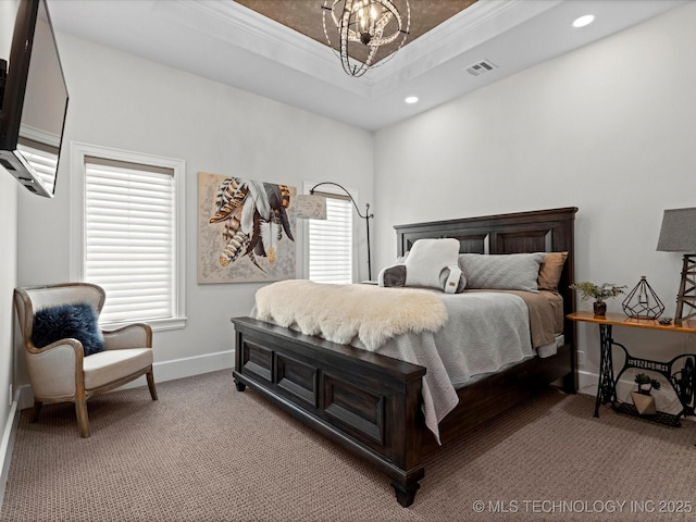 bedroom with visible vents, a tray ceiling, light carpet, crown molding, and a chandelier