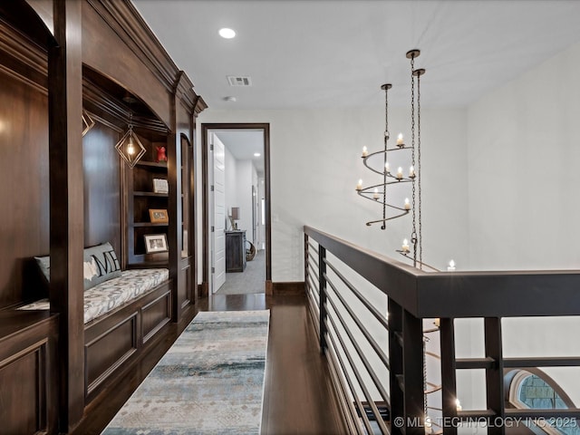 hall featuring recessed lighting, visible vents, an upstairs landing, and dark wood finished floors