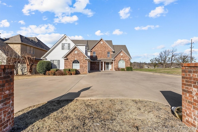 traditional-style home with brick siding and driveway