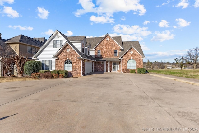 view of front of property featuring concrete driveway, a garage, brick siding, and a shingled roof