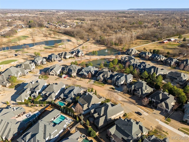 drone / aerial view featuring a residential view and a water view