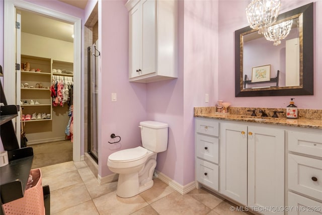 full bath with vanity, baseboards, a stall shower, tile patterned floors, and toilet