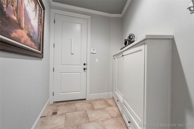 entryway featuring crown molding and baseboards