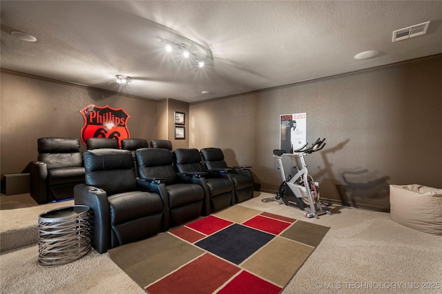 cinema room featuring visible vents, a textured ceiling, and crown molding