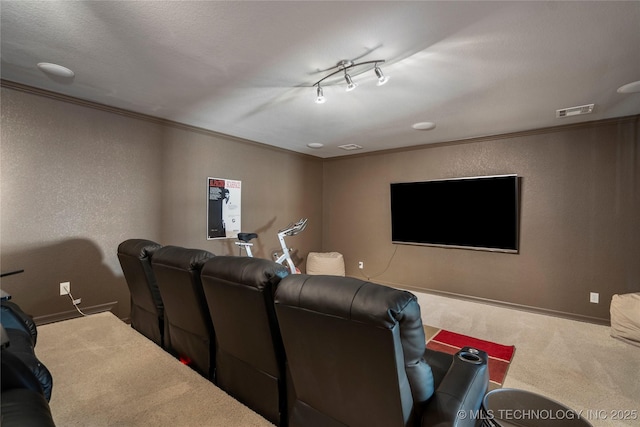 cinema room with crown molding, a textured wall, visible vents, and carpet floors