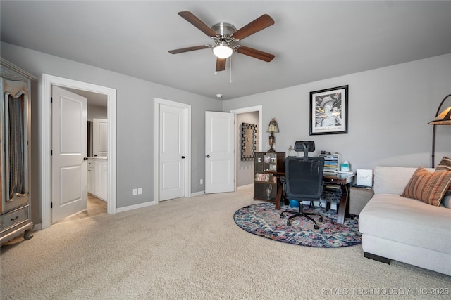 office featuring light colored carpet, baseboards, and ceiling fan